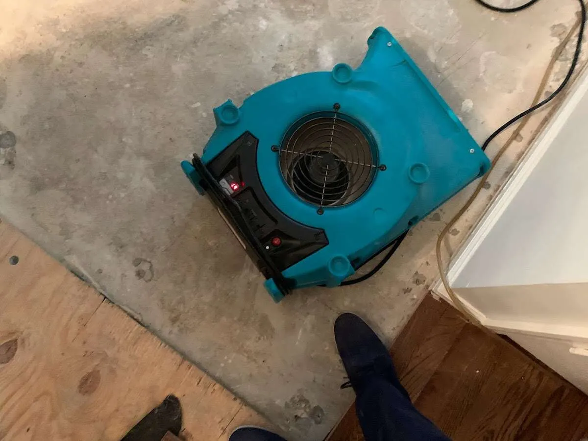 Air mover drying subfloor during Leak Detection & Repair in McSwain